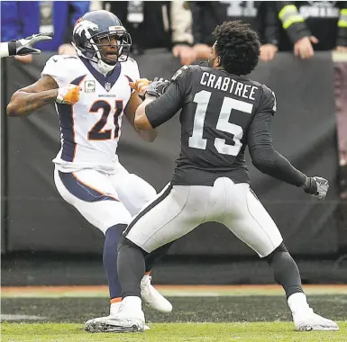  ?? Ben Margot / Associated Press ?? Raiders receiver Michael Crabtree throws a punch in a first-quarter fight with cornerback Aqib Talib.