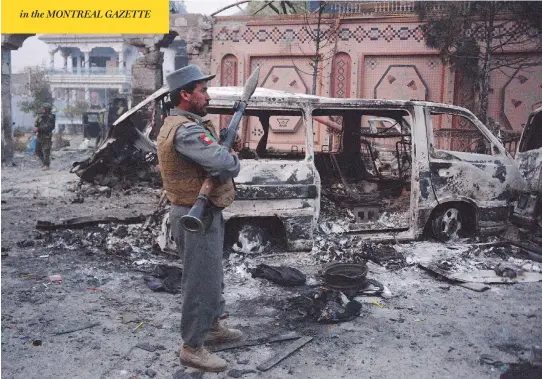 ?? NOORULLAH SHIRZADA/AFP/GETTY IMAGES ?? Afghan security forces inspect the site of an attack on British charity Save the Children’s office on Wednesday, after Islamic State gunmen blasted their way into the British aid group’s compound in the eastern city of Jalalabad, killing at least four...