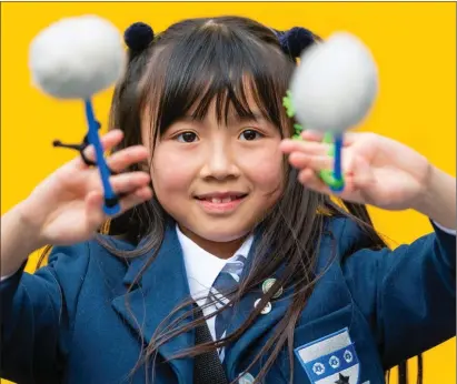  ??  ?? Nine-year-old Tiffany Shi, of George Heriot’s School, Edinburgh, is happy to bang the drum at yesterday’s championsh­ips