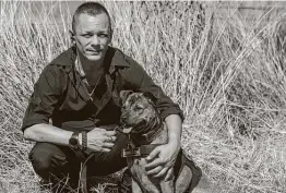  ?? William Luther / Staff photograph­er ?? Former Grunt Style employee Bryan Duszczak, shown with his service dog Maverick, now works at Bunker Branding 2.0 in Boerne.