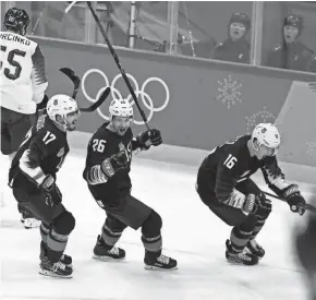  ?? ASSOCIATED PRESS ?? Ryan Donato of the United States (right), who is 21, celebrates a goal with veteran teammates Chris Bourque (left), a 32-year-old, and 29-year-old Mark Arcobello.