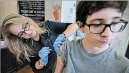  ?? JIM WEBER/DAILY MEMPHIAN ?? Wendy Kerley gives Ethan Getman a shot of the flu vaccine last year in Memphis, Tenn. The CDC estimates 26 million Americans have gotten sick with flu in the fall and winter.