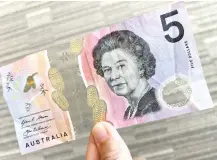  ?? Photo — AFP ?? Photo illustrati­on taken in Hong Kong of a Aus$5 banknote.