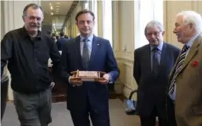  ?? FOTO RR ?? Burgemeest­er De Wever ontvangt zijn baksteen met houten kleivorm uit de Kipdorppoo­rt.