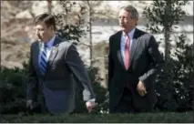  ?? THE ASSOCIATED PRESS ?? Rep. Mike Johnson, R-La., left, followed by House Freedom Caucus member Rep. Mark Sanford, R-S.C., arrives at the White House in Washington on March 23.