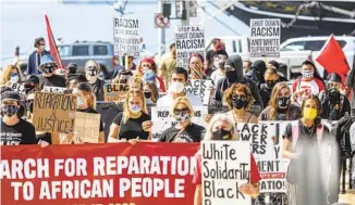  ?? SANDY HUFFAKER ?? The March for Reparation­s to African People was organized by the Uhuru Solidarity Movement.