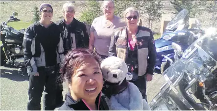  ?? TINA BUCKTHORP ?? Tina Buckthorp, front, holds Nomad Bear, a Women In the Wind mascot. Behind her are, from left, Becky Kent, Pat Walker, Crystal McConnell and Trish Collins. These members of the Chinook Outriders Chapter of WITW were riding the Highwood Pass to review...