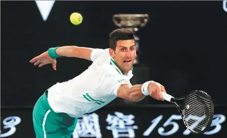  ?? REUTERS ?? Serbia’s Novak Djokovic stretches for a return during the Australian Open final against Russia’s Daniil Medvedev at Melbourne Park on Sunday. Djokovic won 7-5, 6-2, 6-2 to claim a historic ninth title at the Grand Slam tournament.