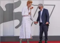  ?? AP PHOTO/DOMENICO STINELLIS ?? Director Pedro Almodovar, right, and actress Tilda Swinton pose on the red carpet of the movie ‘The human voice’ during the 77th edition of the Venice Film Festival at the Venice Lido, Italy, Thursday. The Venice Film Festival goes from Sept. 2 through Sept. 12. Italy was among the countries hardest hit by the coronaviru­s pandemic, and the festival will serve as a celebratio­n of its re-opening and a sign that the film world, largely on pause since March, is coming back as well.