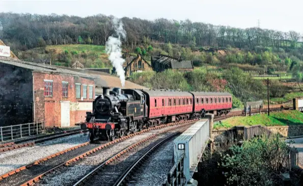  ??  ?? Ivatt ‘2MT’ No. 41241 rolls into Keighley with a pair of suburban Mk 1s. Russ Hillier ran this event having arranged for the ‘Worth Valley’ 2‑6‑2T to be turned to face downhill. The landscape in this picture has changed significan­tly following the constructi­on of houses on the hill behind around 20 years ago.