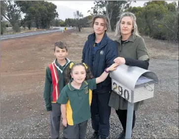  ??  ?? TOO CLOSE FOR COMFORT: From left, Eamon, 10, Harper, 8, Neeve, 13, and Cassy Kelly at their Lower Norton driveway. The children were nearly hit by a truck while waiting for their school bus. Picture: PAUL CARRACHER