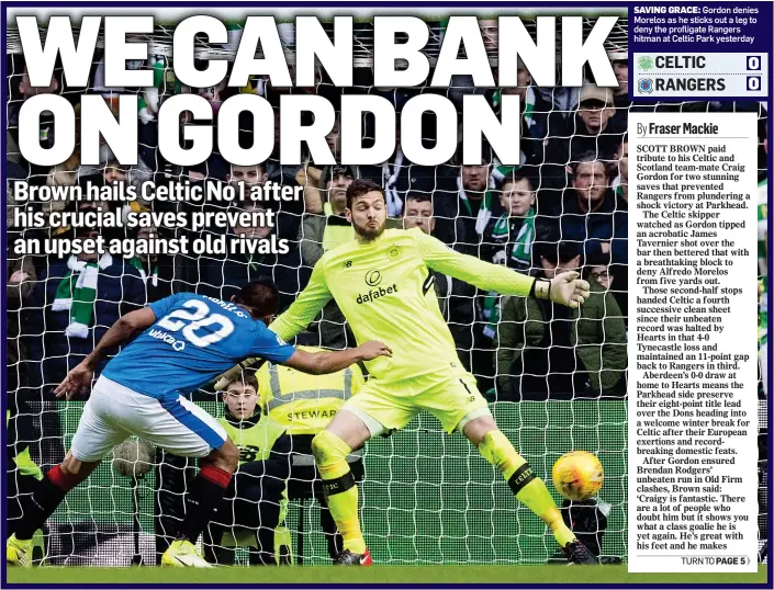  ??  ?? SAVING GRACE: Gordon denies Morelos as he sticks out a leg to deny the profligate Rangers hitman at Celtic Park yesterday