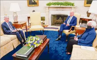  ?? Evan Vucci / Associated Press ?? President Joe Biden meets with Federal Reserve Chairman Jerome Powell, left, and Treasury Secretary Janet Yellen on Tuesday in the Oval Office of the White House.