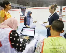  ?? (Muhammad Hamed/Reuters) ?? ELECTION WORKERS count votes following Sunday’s presidenti­al election at a vote-counting center in Tunis on Monday.