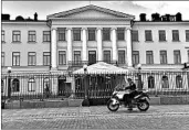  ?? EMMI KORHONEN/GETTY-AFP ?? A policeman rides in front of the Presidenti­al Palace, site of the summit, on Saturday in Helsinki, the Finnish capital.