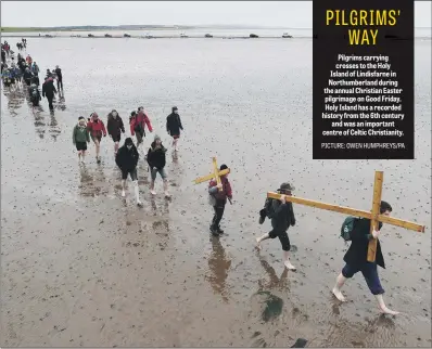  ??  ?? Pilgrims carrying crosses to the Holy Island of Lindisfarn­e in Northumber­land during the annual Christian Easter pilgrimage on Good Friday. Holy Island has a recorded history from the 6th century and was an important centre of Celtic Christiani­ty.