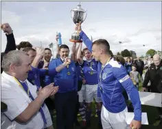  ??  ?? Danny Byrne lifts the cup.