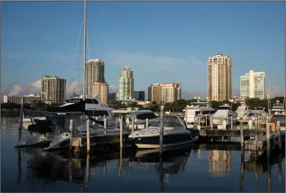  ?? Monica Herndon/Washington Post ?? Boats moored in the Vinoy Yacht Club in front of the St. Petersburg skyline on April 20, 2018.
