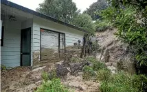  ?? ?? Homes in Enner Glynn have been engulfed in mud and rocks.