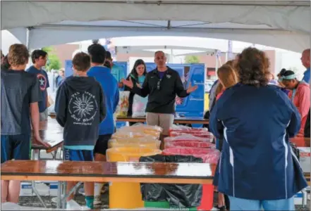  ?? SUBMITTED PHOTO ?? Cradles to Crayons ‘Champion Volunteer’ Mike Pauciello orients student volunteers from Springfiel­d Middle School — participan­t in the “Battle of the Schools” collection competitio­n — to sort and quality-check clothing donations at Metroplex May Day.