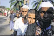  ?? BINSAR BAKKARA/AP ?? Rohingya migrants line up for breakfast Sunday at a temporary shelter in Indonesia. Thousands more are believed to be trapped at sea, and the United Nations says time is running out for them.