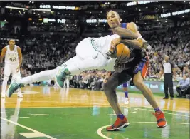  ?? Bob Dechiara ?? USA Today Findlay Prep product Avery Bradley grabs Celtics guard Kyrie Irving in the second half of the Pistons’ 118-108 victory Monday at TD Garden.