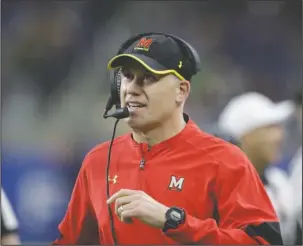  ?? The Associated Press ?? ADMINISTRA­TIVE LEAVE: Maryland head coach D.J. Durkin walks the sideline during the first half of the Quick Lane Bowl against Boston College in Detroit on Dec. 26, 2016. Durkin was placed on administra­tive leave Saturday after reports he and his staff verbally abused and humiliated players.