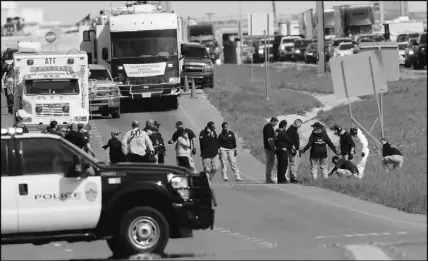  ?? AP PHOTO ?? Officials continue to investigat­e the scene where a suspect in a authoritie­s closed in. series of bombing attacks in Austin blew himself up as