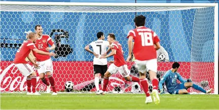  ??  ?? RUSSIA’s midfielder Denis Cheryshev (C) scores during the Russia 2018 World Cup Group A football match between Russia and Egypt at the Saint Petersburg Stadium in Saint Petersburg on June 19.