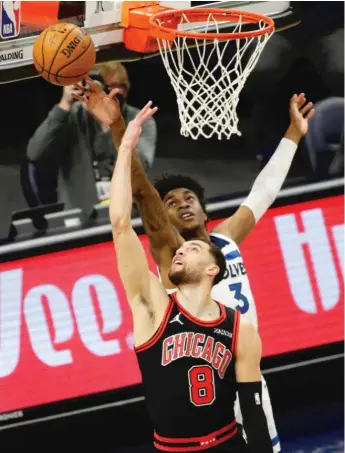  ?? AP ?? Timberwolv­es forward Jaden McDaniels blocks a shot by Bulls guard Zach LaVine in the first quarter.