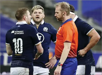  ??  ?? Scotland stand-off Finn Russell pleads his case with referee Wayne Barnes after being sent off