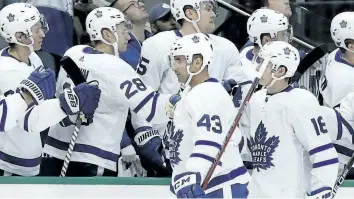  ?? TONY GUTIERREZ/ THE ASSOCIATED PRESS ?? Nazem Kadri, left, and Mitch Marner celebrate Kadri’s first goal with the Leafs bench in their 4- 1 win over the Dallas Stars on Thursday.