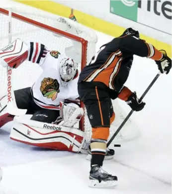  ?? JAE C. HONG/THE ASSOCIATED PRESS ?? Blackhawks goalie Corey Crawford, left, blocks a shot by Anaheim’s Patrick Maroon in Game 2 play Tuesday night.