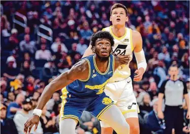  ?? Carlos Avila Gonzalez/The Chronicle ?? Warriors center James Wiseman boxes out Utah’s Walker Kessler during a game at Chase Center on Dec. 28.