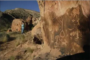  ?? JOHN LOCHER — THE ASSOCIATED PRESS FILE ?? Susie Gelbart walks near petroglyph­s at the Gold Butte National Monument near Bunkervill­e, Nev. Interior Secretary Ryan Zinke said he’s recommendi­ng that none of 27 national monuments carved from wilderness and ocean and under review by the Trump...