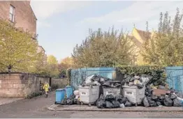  ?? KIERAN DODDS/THE NEW YORK TIMES ?? Trash is piled up Wednesday in the Finnieston area of Glasgow, Scotland, near the site of the COP26 climate summit.