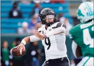  ?? Gerald Herbert / Associated Press ?? Cincinnati quarterbac­k Desmond Ridder passes during the first half of a game against Tulane.