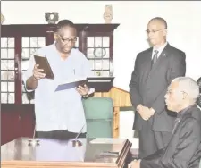  ?? The Presidency photo) (Ministry of ?? Patrick Yarde reciting the Oath of Office in the presence of President David Granger