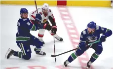  ?? (Anne-Marie Sorvin-USA TODAY Sports/TNS) ?? OTTAWA SENATORS forward Colin White (36) reaches for the puck through Vancouver Canucks forward Jake Virtanen (18) and defenseman Troy Stecher (51) during the third period at Rogers Arena.