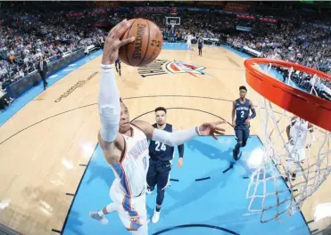  ?? AFP ?? RUSSELL Westbrook (0) of the Oklahoma City Thunder dunks the ball during the game against the Memphis Grizzlies on April 11, 2018 at Chesapeake Energy Arena in Oklahoma City, Oklahoma.
