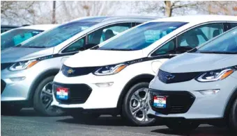  ?? AP PHOTO/DAVID ZALUBOWSKI ?? A row of 2021 Chevrolet Bolt electric sedans in shown in Loveland, Colo.