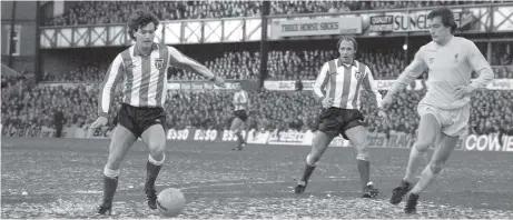  ??  ?? Home-grown midfielder Kevin Arnott lines up a shot for Sunderland at the Roker End as Liverpool’s Colin Irwin moves in. Pop Robson looks on.