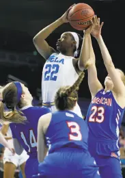  ?? Luis Sinco / Los Angeles Times ?? UCLA’s Kennedy Burke, who scored 15 points, puts up a shot against three American defenders.