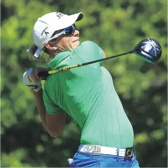  ?? VAUGHN RIDLEY/GETTY IMAGES ?? Alena Sharp hits her tee shot at the 18th hole in the first round of the Manulife LPGA Classic in Cambridge, Ont., on Thursday. Sharp ended the day as the top Canadian, two shots off the lead.