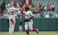  ?? GAIL BURTON — THE ASSOCIATED PRESS ?? Philadelph­ia Phllies’ Cesar Hernandez, left, and Odubel Herrera celebrate their 4-1 win over the Baltimore Orioles in a baseball game Wednesday in Baltimore.