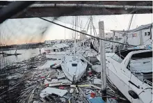  ?? DAVID GOLDMAN THE ASSOCIATED PRESS ?? Damaged boats sit among debris in a marina in the aftermath of hurricane Michael in Panama City, Fla., Friday.