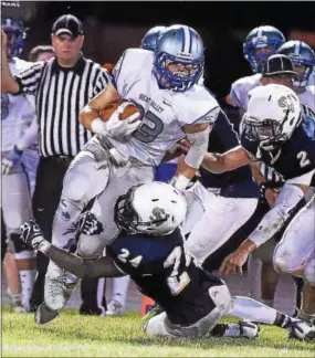  ?? PETE BANNAN — DIGITAL FIRST MEDIA ?? Great Vallley running back Alex Crouse is tackled by Sun Valley’s Quentin West in the second quarter Friday.