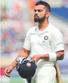  ?? AP ?? Indian captain Virat Kohli leaves the field after being dismissed.