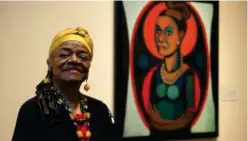  ?? File/associated Press ?? Faith Ringgold poses in front of a painted self-portrait at the National Museum of Women in the Arts in Washington, June 19, 2013.