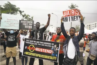  ?? Sunday Alamba / Associated Press ?? Demonstrat­ors protest police brutality in Lagos, Nigeria, for a seventh day. At least 10 people have been killed and hundreds injured across the nation, according to Amnesty Internatio­nal.